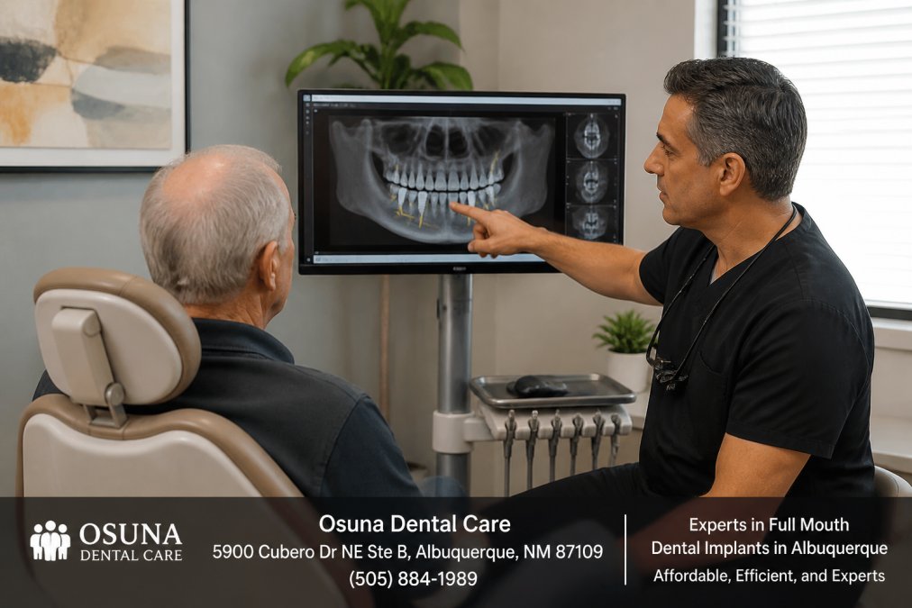 Senior patient seated in modern dental chair during consultation, with dentist pointing to 3D imaging displayed on monitor showing implant placement angles