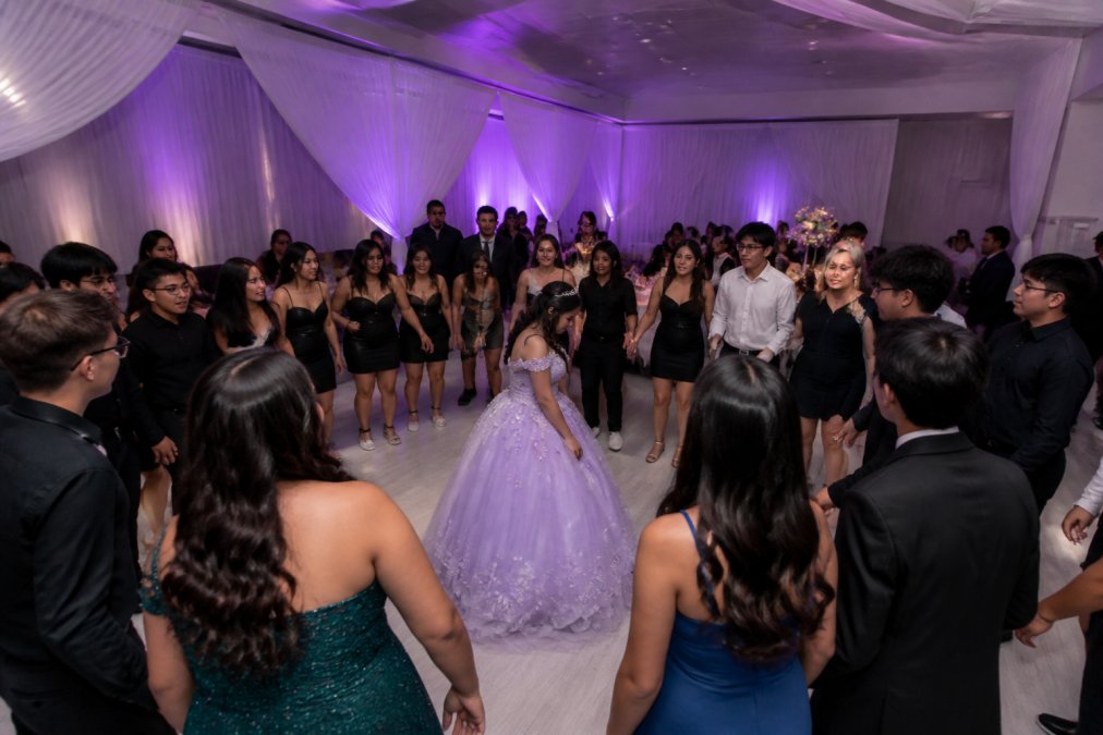 Elegant quinceanera Maryland celebration with purple lighting and guests dancing in a modern lounge venue