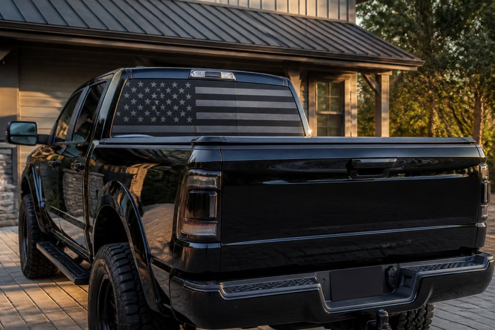 Glossy black truck with a matte American flag decal, showcasing custom vinyl graphics for black trucks.