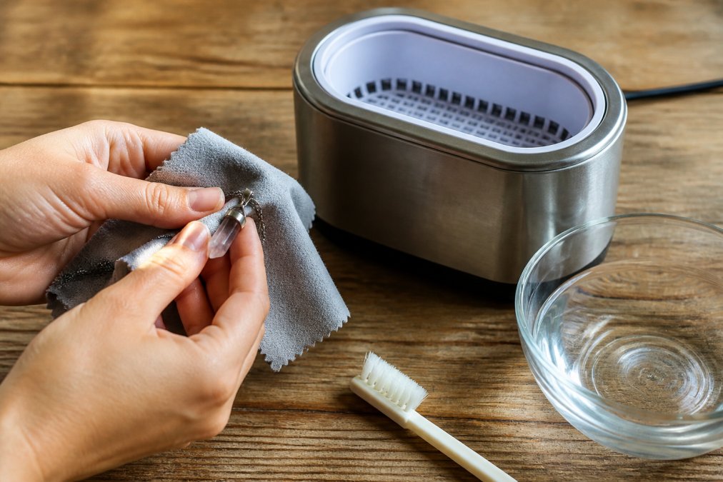 Step-by-step guide to safely cleanse crystal jewelry using a soft cloth, ultrasonic cleaner, and gentle brush.