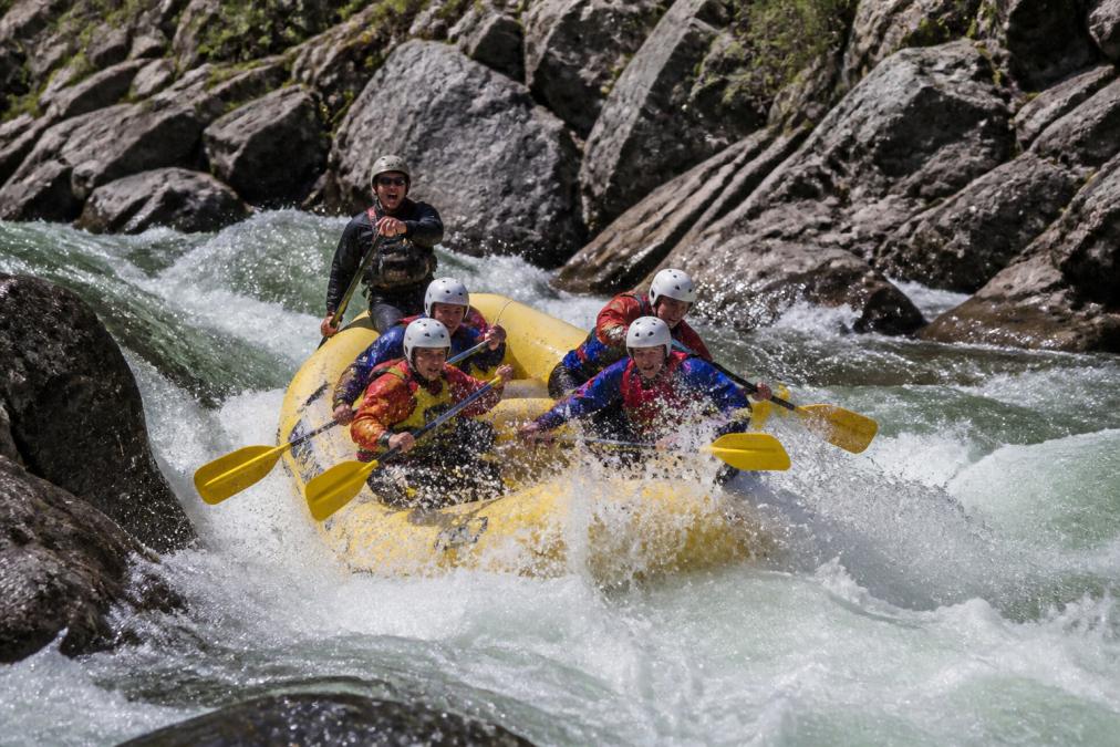 Experienced rafters navigate a steep Class V rapid while whitewater rafting California on Cherry Creek.
