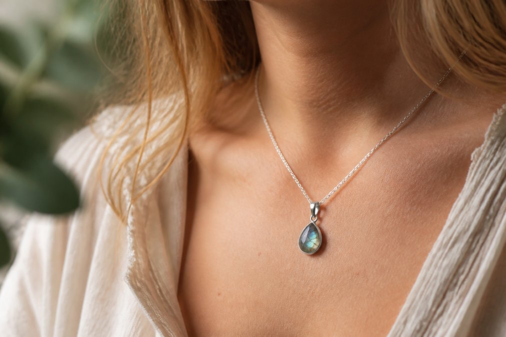 Labradoriet edelsteen ketting met zilveren hanger die elegant om de hals valt in zacht natuurlijk licht