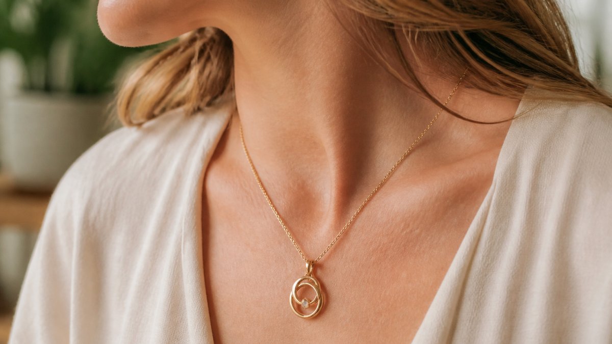 Close-up of a woman's neck and shoulders wearing an elegant personalized necklace with a pendant, soft natural lighting highlighting the jewelry detail and craftsmanship