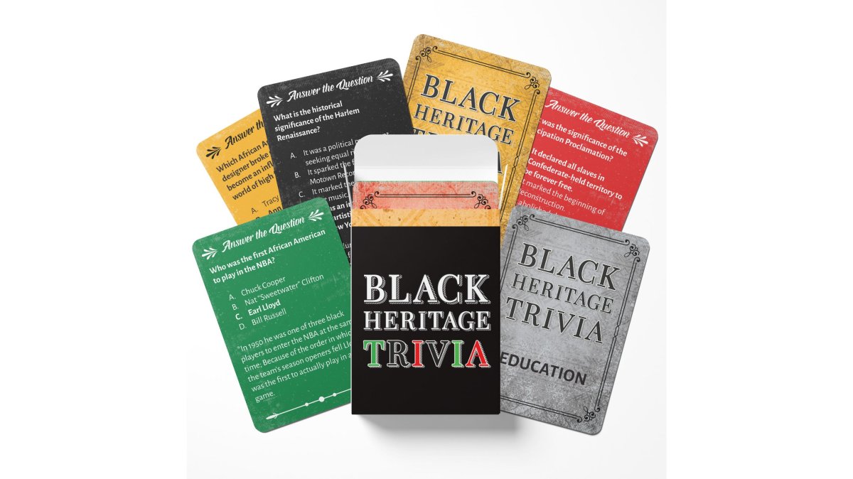 A family gathered around a coffee table playing Black Heritage Trivia Game Cards, with a partially assembled Black history puzzle nearby and a word search book open, warm lamp lighting in a cozy living room