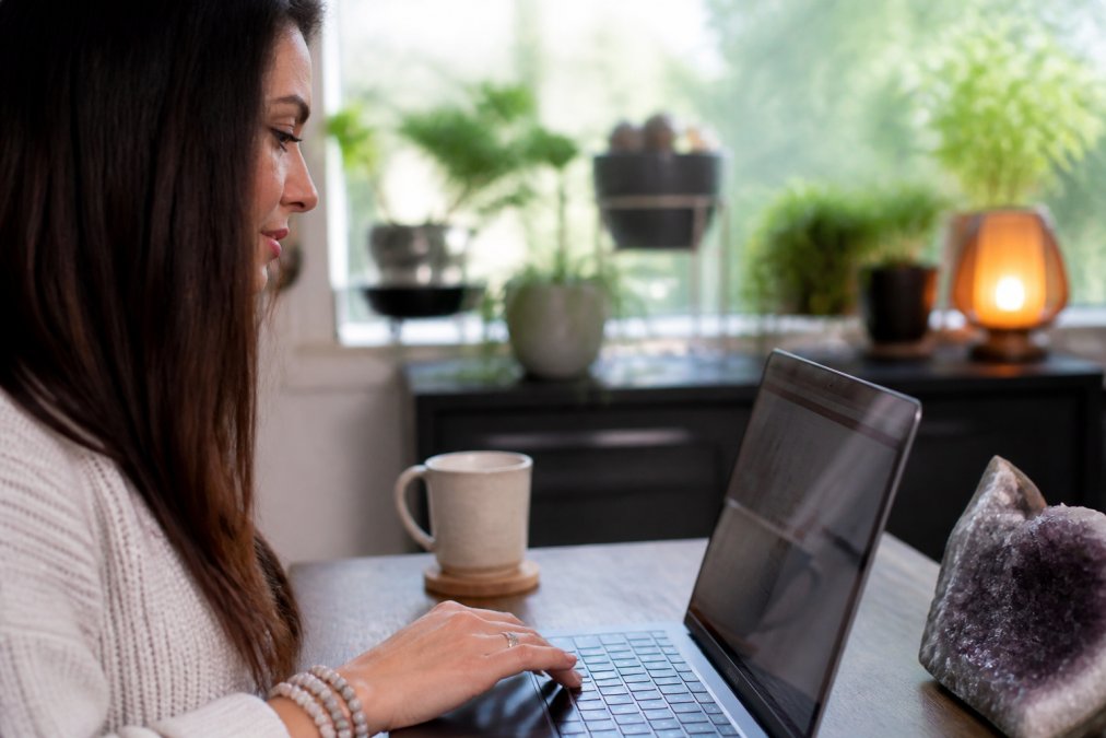 Book Intuitive Soul Guidance: A Step-by-Step Guide 2 Close-up of hands on a laptop or phone, navigating a booking calendar with a warm, welcoming interface