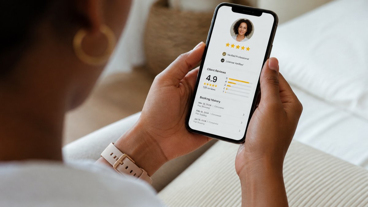 Person viewing a professional's verified profile on a smartphone, showing credentials badge, client review ratings, and booking history clearly displayed on screen