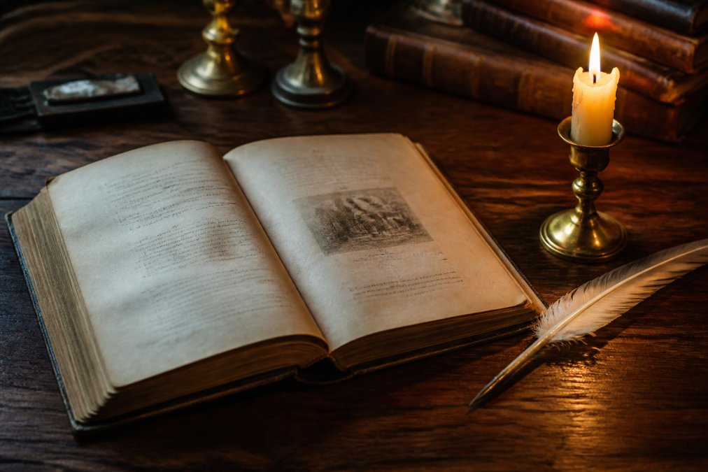 An antique hardcover copy of The Count of Monte Cristo lying open on a dark wooden desk, a vintage quill and a single lit candle casting warm amber light across the pages
