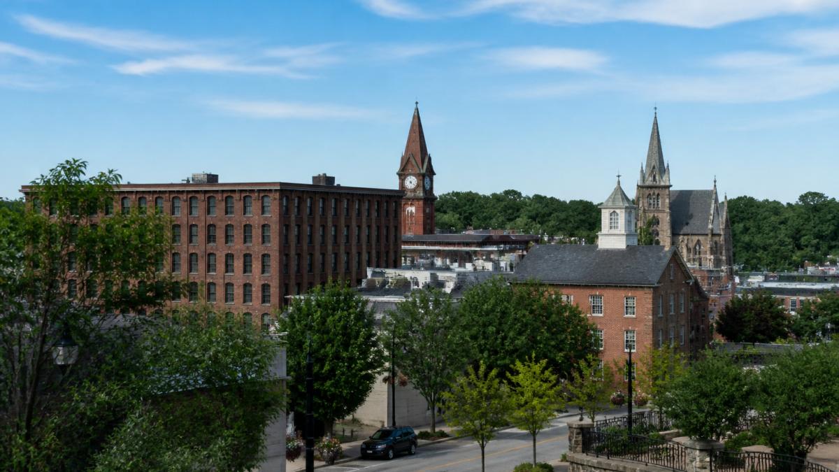 Scenic view of Bristol's downtown area with historic buildings, tree-lined streets, and local storefronts on a sunny day