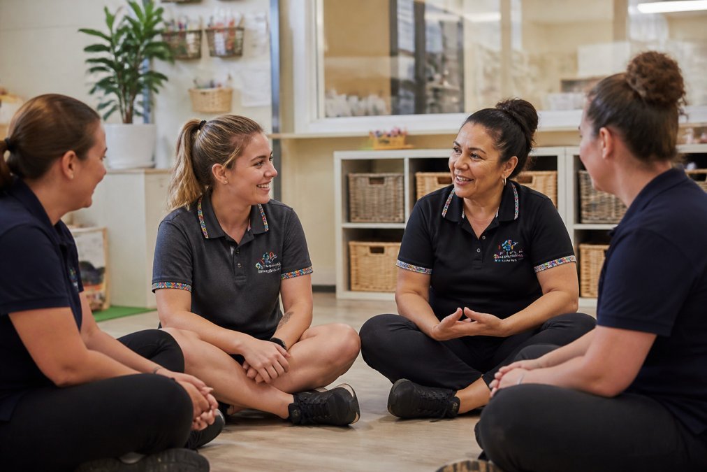 Early childhood educators sitting in a circle, building child safe culture in childcare through team meetings.