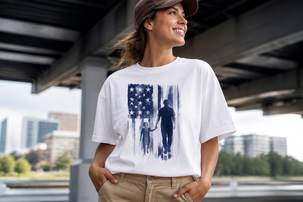 Close-up of a person wearing a premium graphic tee featuring an original design, showcasing the print quality and comfortable fit against their body in natural daylight