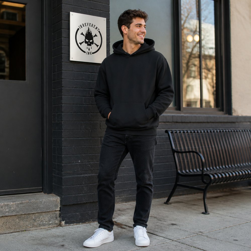Young adult wearing a sarcastic graphic hoodie styled with dark jeans and clean white sneakers, standing confidently in natural daylight with a relaxed posture, showing how the design reads as intentional casual wear