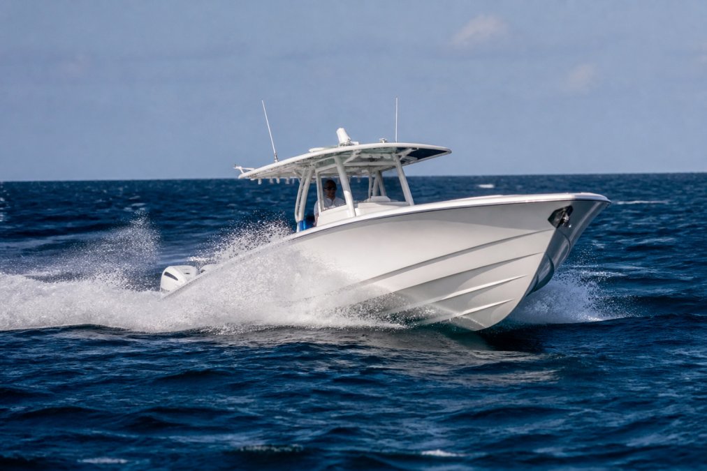 Center console boat cutting through choppy Atlantic waters, demonstrating how deep-V hull handles rough sea conditions with spray and wave action visible