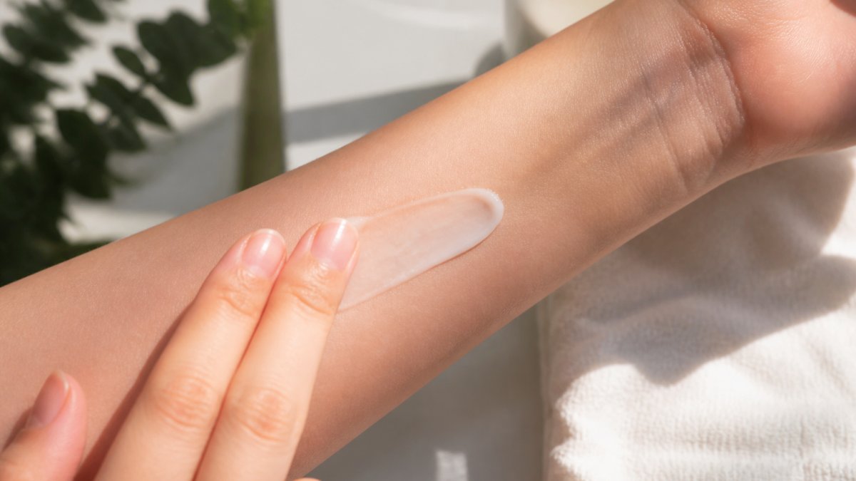 Close-up of a person's inner forearm showing a small amount of lightweight gel-cream moisturizer applied to the skin in natural morning light