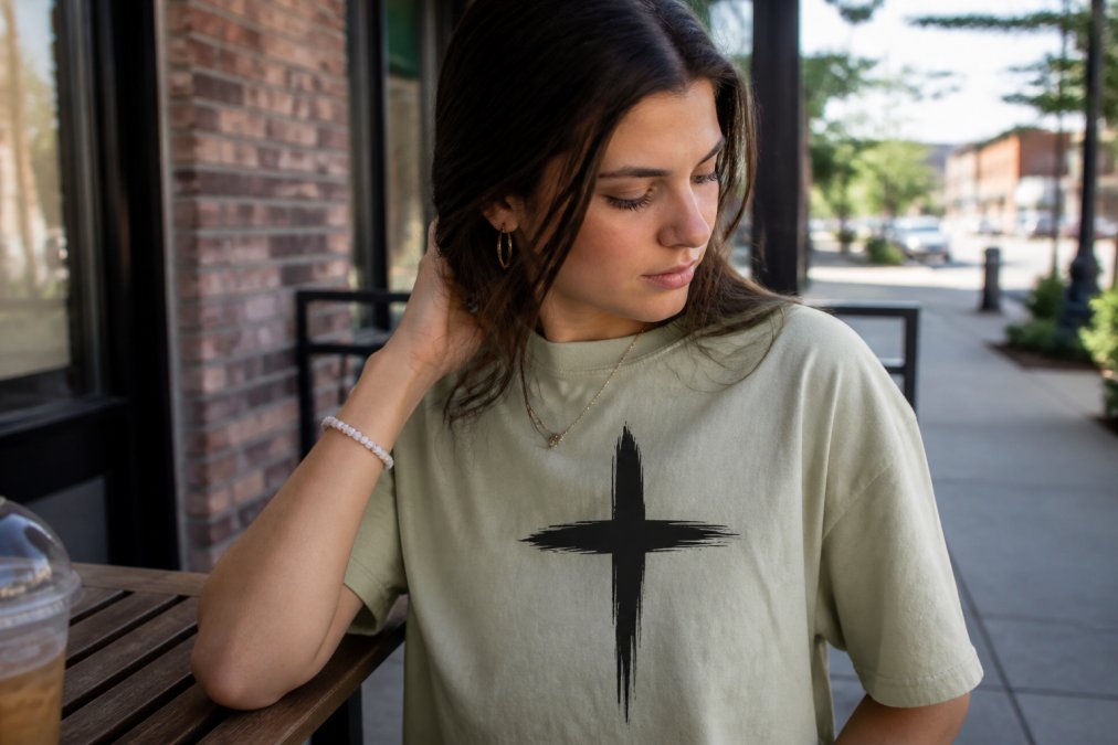 Close-up of person wearing Christian apparel with visible scripture or faith-based design, captured in casual everyday moment with natural lighting