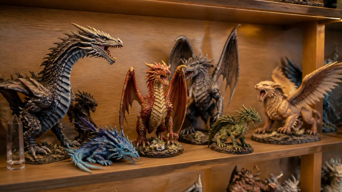 Carefully arranged collectible fantasy figures including articulated dragons and detailed creatures displayed on a wooden shelf with warm accent lighting, showing varied heights and angles in a curated collection