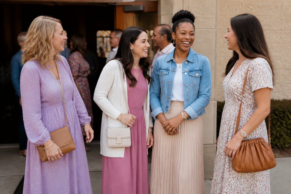 Flat lay of a complete church outfit including modest dress in soft neutral tone, closed-toe shoes, cream cardigan, and faith-inspired accessories arranged on light background
