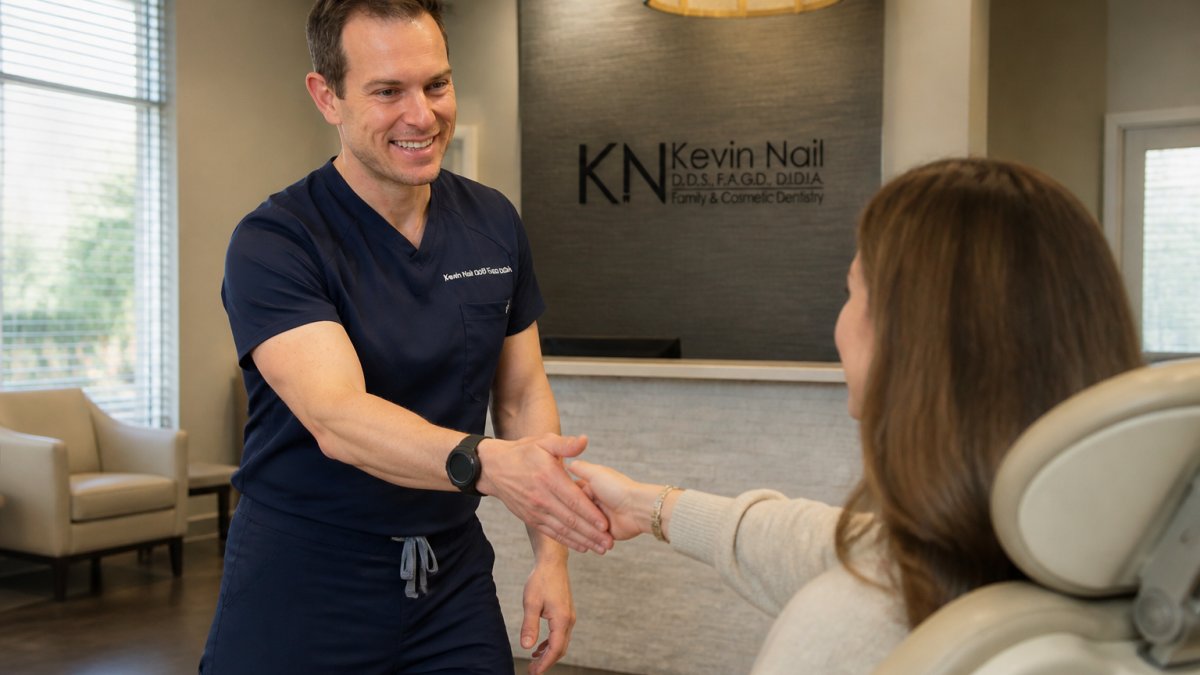 Dental professional greeting patient warmly in modern clinical environment with natural lighting, comfortable seating, and welcoming atmosphere