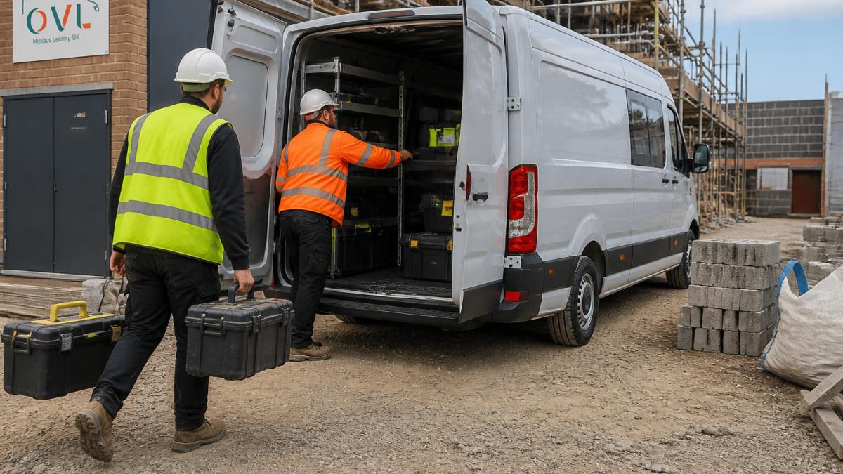 Commercial crew van parked at a job site with workers loading tools and equipment into the rear cargo area in daylight