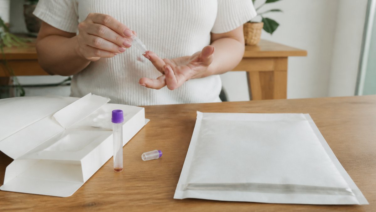 Step-by-step guide for collecting a fingerprick blood sample at home using a test kit and return envelope