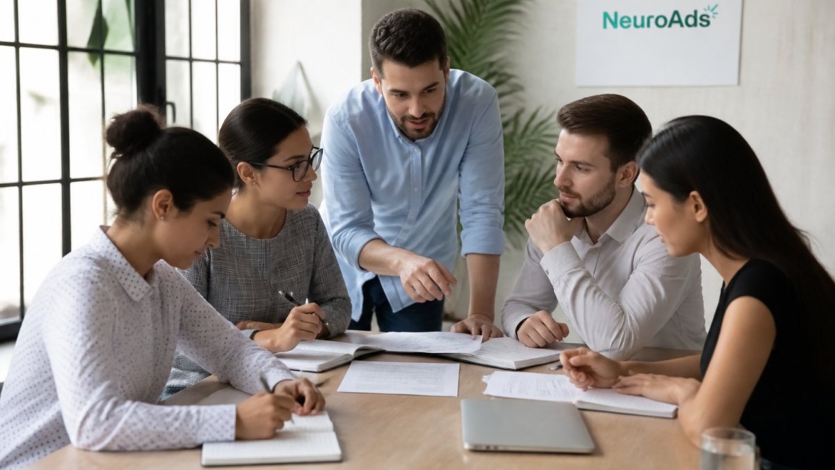 Marketing team reviewing conversational AI analytics and customer interaction data on multiple screens in modern office with natural lighting