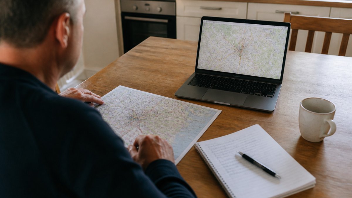 Person at a table comparing local map data against the national crime rate