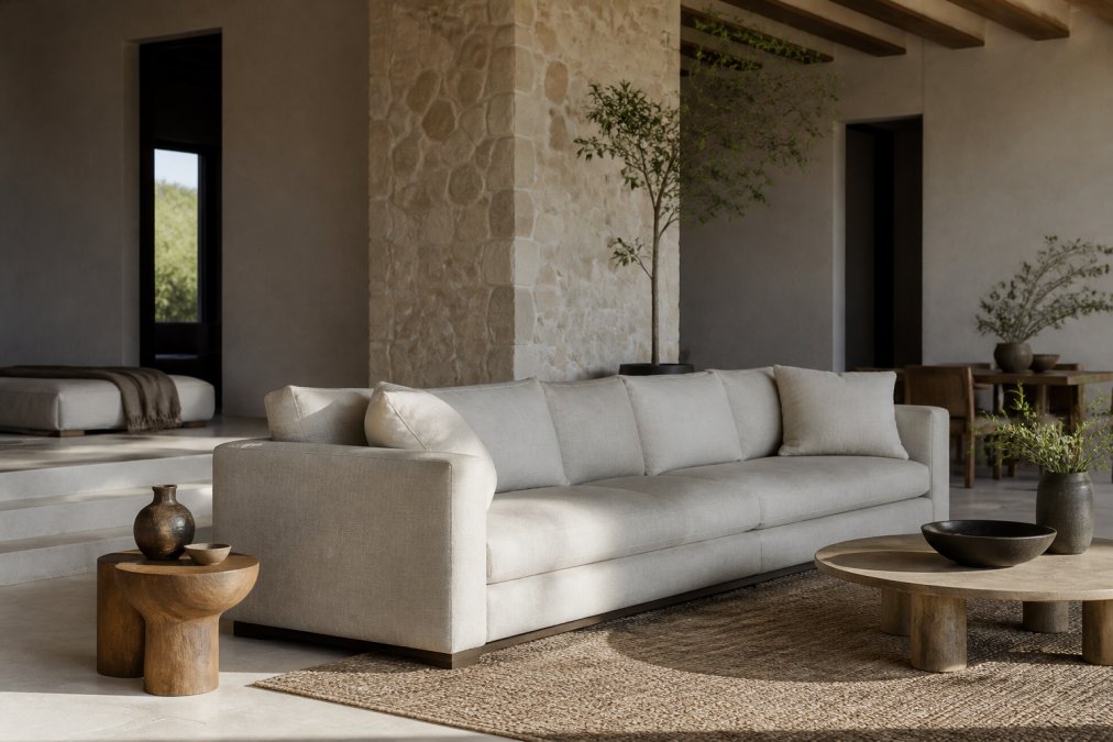 Modern living room featuring a handcrafted luxury sofa with clean lines, natural wood side tables, and neutral upholstery in soft lighting, showcasing contemporary minimalism with architectural details