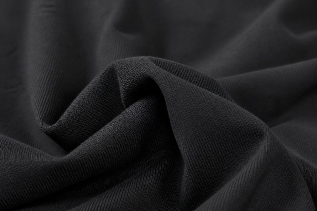 Close-up of fabric textures showing heavyweight cotton, demonstrating quality weave and material composition of premium basics