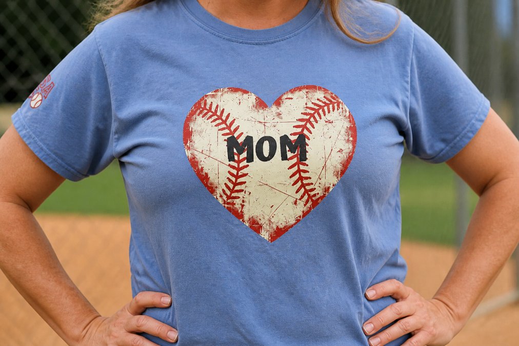Close-up of a well-worn custom patriotic t-shirt showing vibrant screen-printed graphics of a heart-shaped baseball with "MOM" text still crisp and colorfast after multiple washes and active sports wear, fabric texture clearly visible