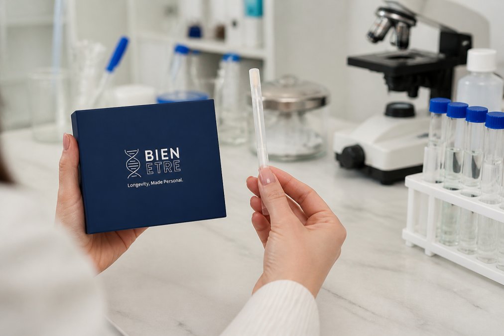 Close-up of hands holding a saliva collection swab kit with laboratory background showing clinical equipment and test tubes, demonstrating the non-invasive nature of at-home DNA testing