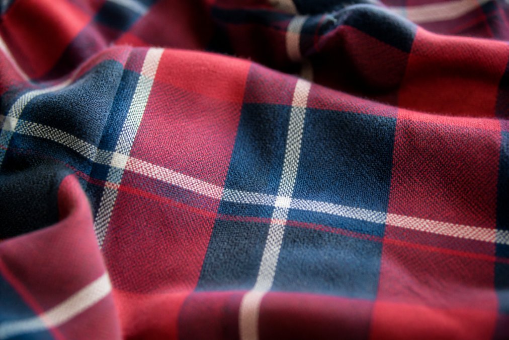 Close-up of smooth, pill-free matching family pajama fabric texture under natural light, showing the tight weave and soft surface