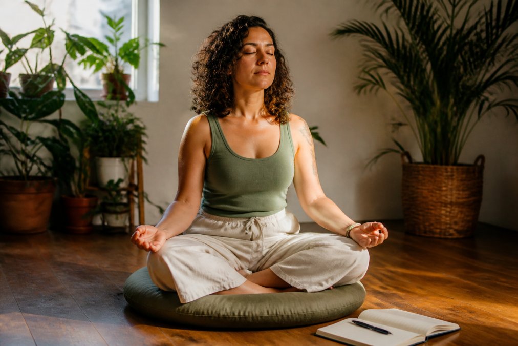 Person meditating in a quiet room.