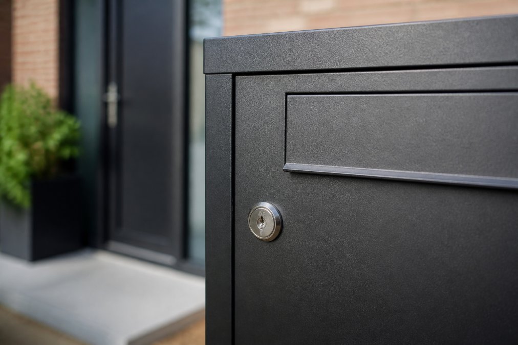 Close-up of steel parcel mailbox showing secure lock mechanism, weatherproof coating, corrosion-resistant finish and strong construction details
