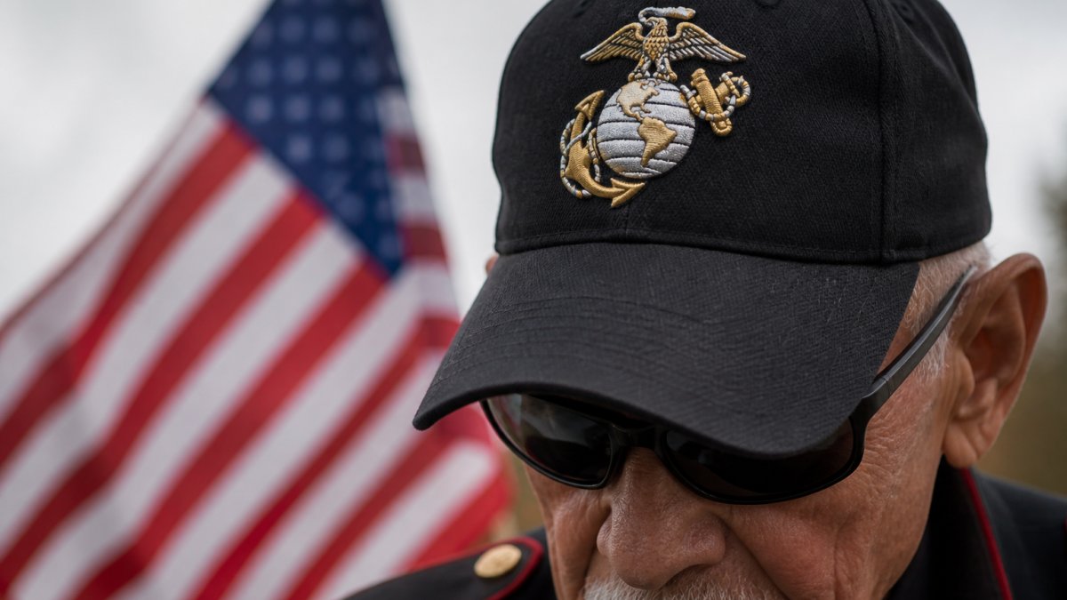 Close-up of Marine Corps veteran wearing an officially licensed cap featuring the Eagle, Globe, and Anchor emblem with clear detail of the embroidered insignia against brushed cotton twill fabric