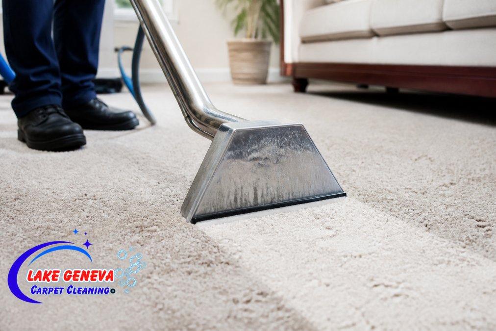 Close-up of professional hot water extraction equipment in action, removing deep soil and water from carpet fibers with visible moisture being extracted during cleaning