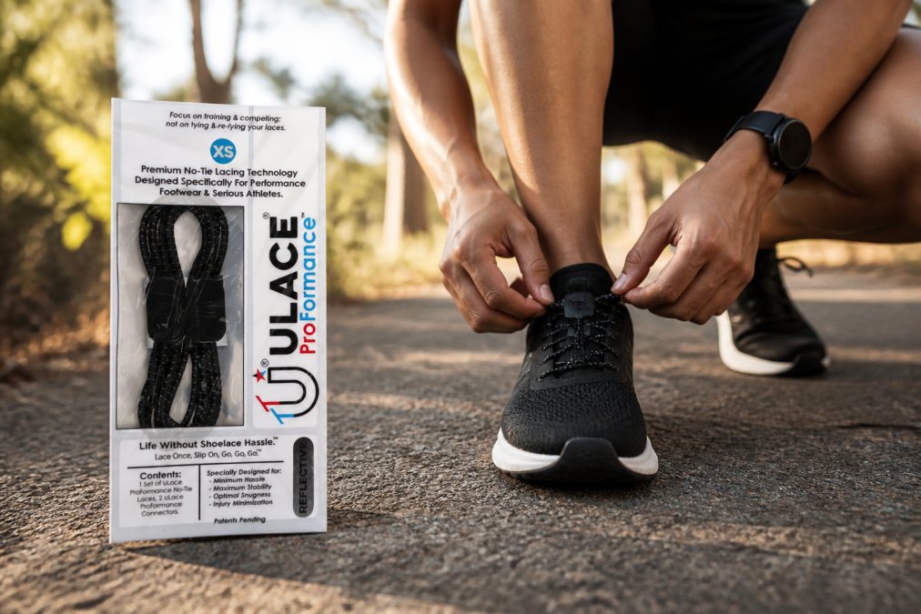 Active athlete in motion wearing sport shoes with elastic laces, demonstrating comfort and secure fit during running or athletic activity, outdoor setting with natural lighting