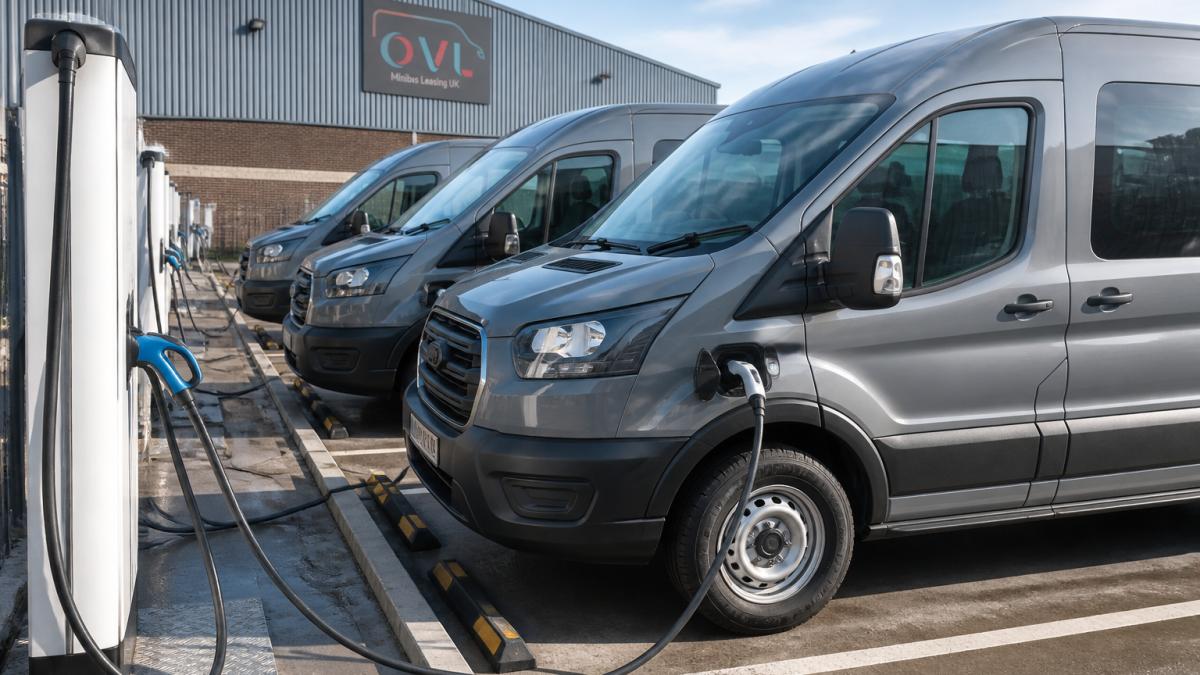 Electric crew vans for urban logistics fleets charging at a modern, well-lit industrial depot.
