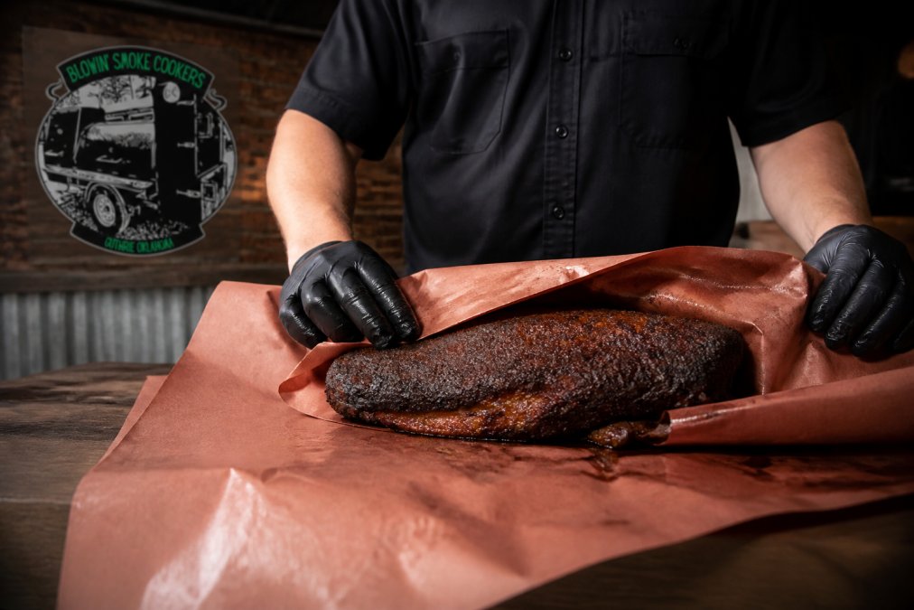 Step-by-step guide showing how to wrap a brisket in butcher paper to lock in moisture and tenderness