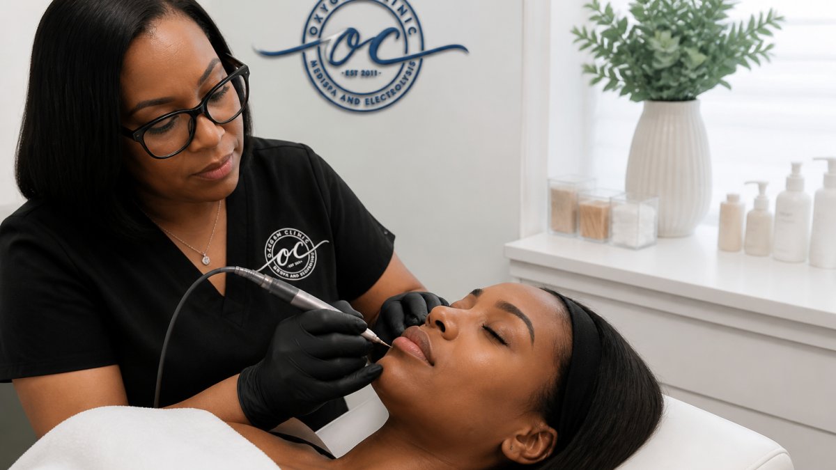 Close-up of a professional electrologist's gloved hands using a fine probe on a client's chin area in a bright, modern treatment room, with the client relaxed and comfortable