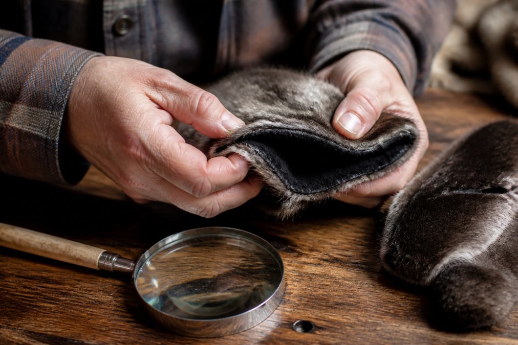 Infographic showing the inspection process for stitching and texture quality of ethically sourced fur mittens