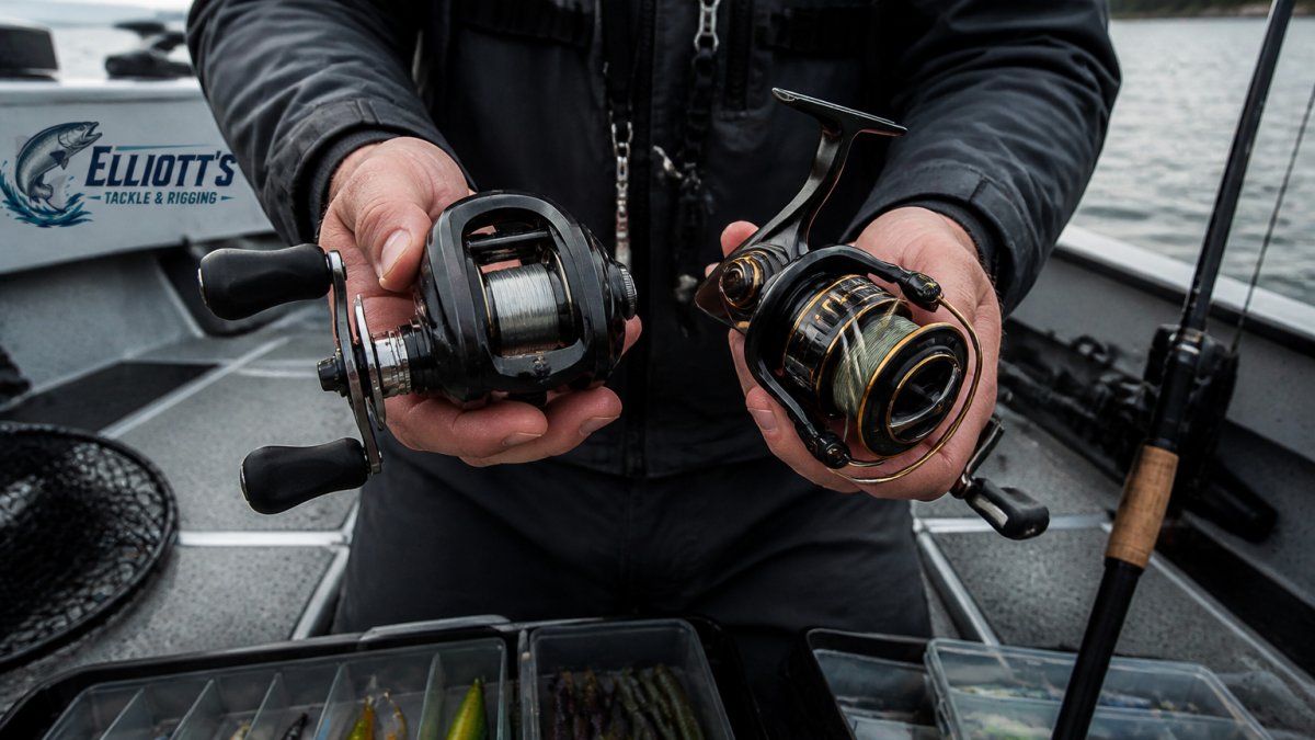 Professional angler's hands holding casting and spinning reels side by side on a modern fishing boat deck with water and rigging visible in background, demonstrating real equipment selection