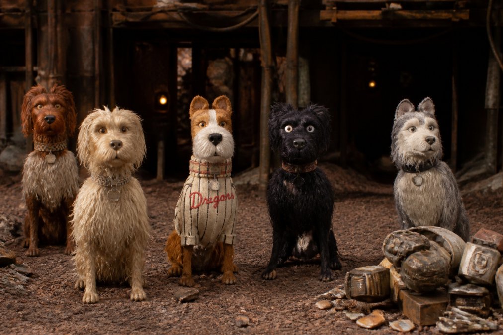 Intricate stop-motion puppet characters with detailed facial expressions and textured materials arranged on a miniature set with professional lighting highlighting the craftsmanship and dimensional depth of each figure