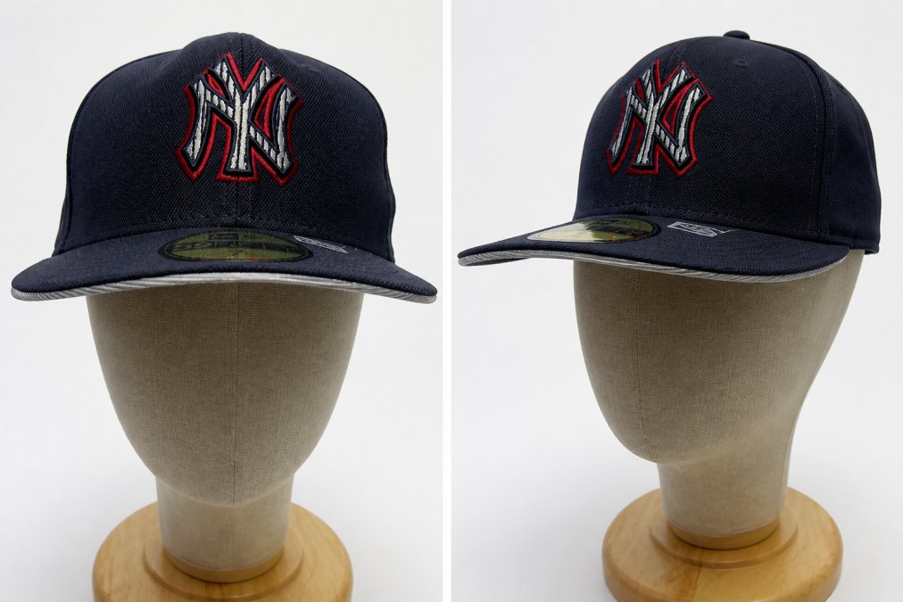 Close-up of a fitted cap's structured crown and flat brim from front and side angles, showing the reinforced panels and embroidered logo detail