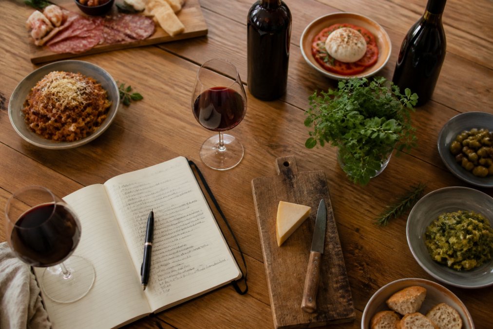 Interactive matrix mapping regional food pairings for artisanal small batch Italian wines on a rustic table.