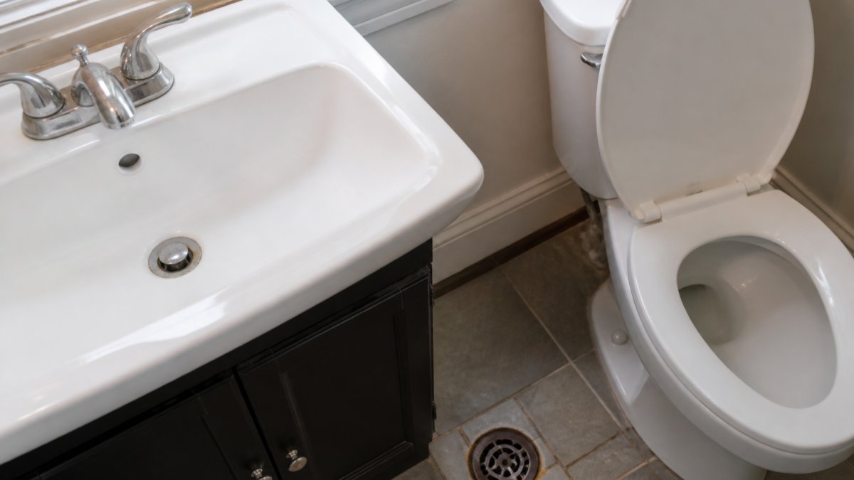 Diagram highlighting common bathroom odor sources including the sink, toilet, and floor drain areas.