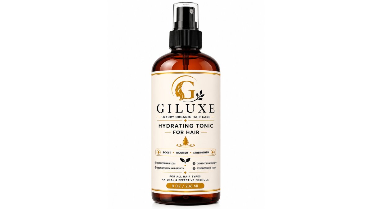 Close-up of Giluxe Hair Growth Oil, Hydrating Tonic, and Pomade arranged with fresh rosemary sprigs and botanical elements on a neutral marble surface with natural daylight