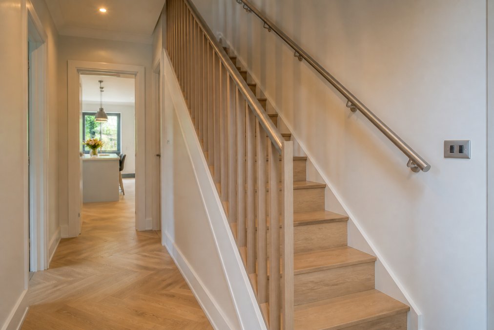 Diagram comparing space-saving timber and metal glass balustrade alternatives for narrow staircases
