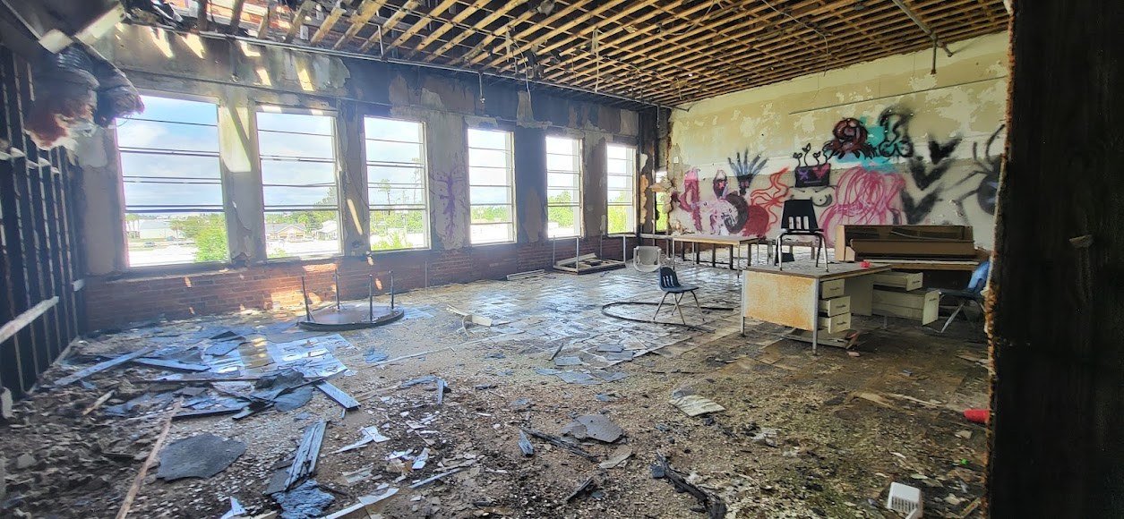 Raven project photo: interior demolition and debris cleanup with exposed framing.