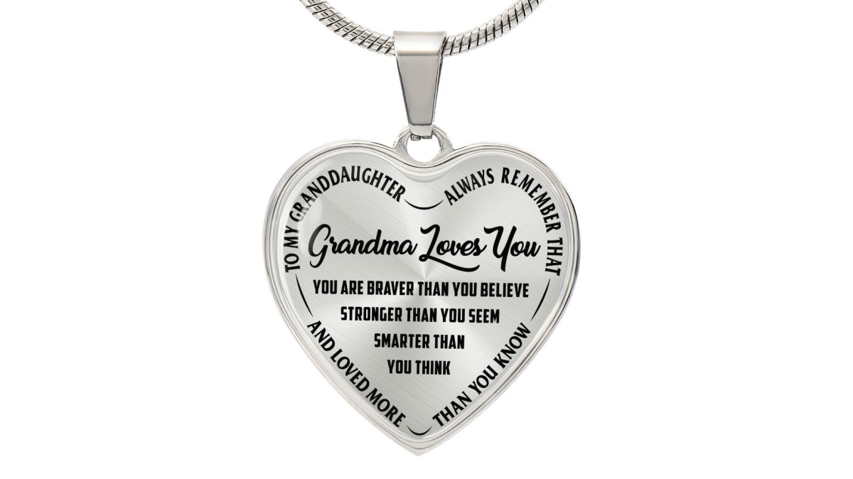 A close-up of a grandmother's hands gently holding a gold heart necklace pendant, with soft natural light in a cozy living room setting