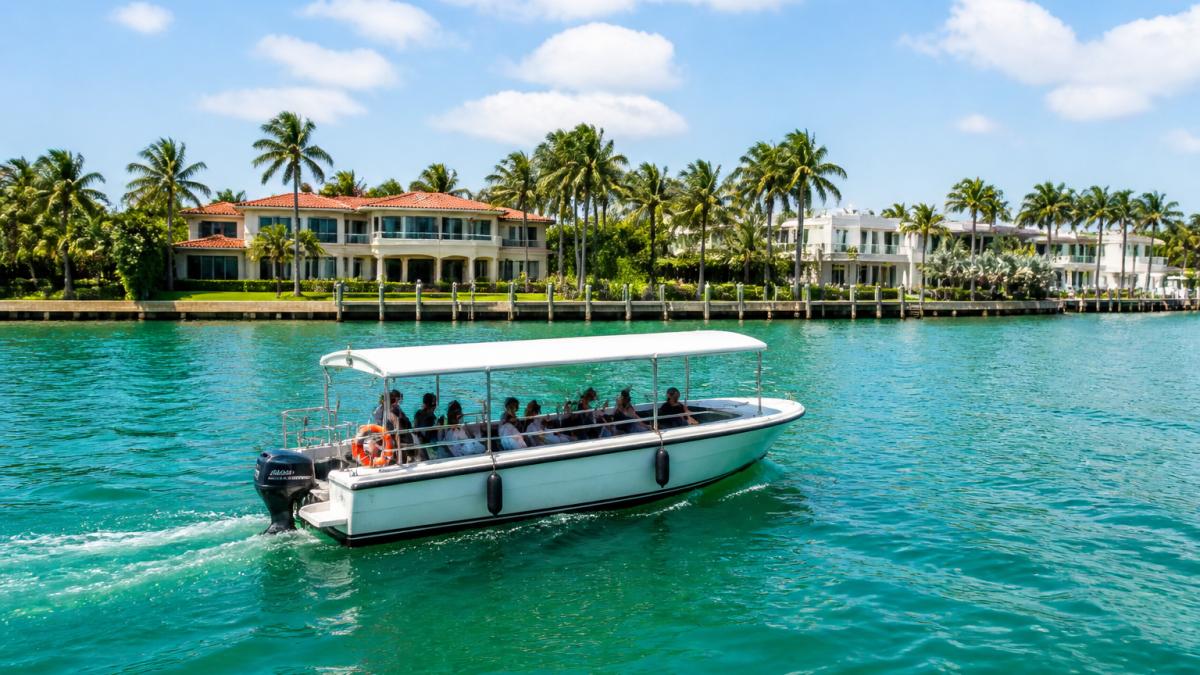 Sightseeing boat cruising Biscayne Bay past luxury waterfront homes on a mansion boat tour