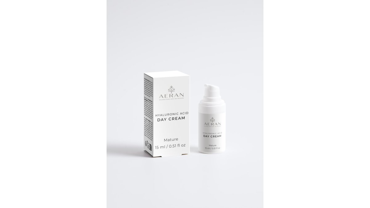 Person applying rich night cream to face with focused attention, demonstrating evening skincare ritual with warm bedroom lighting
